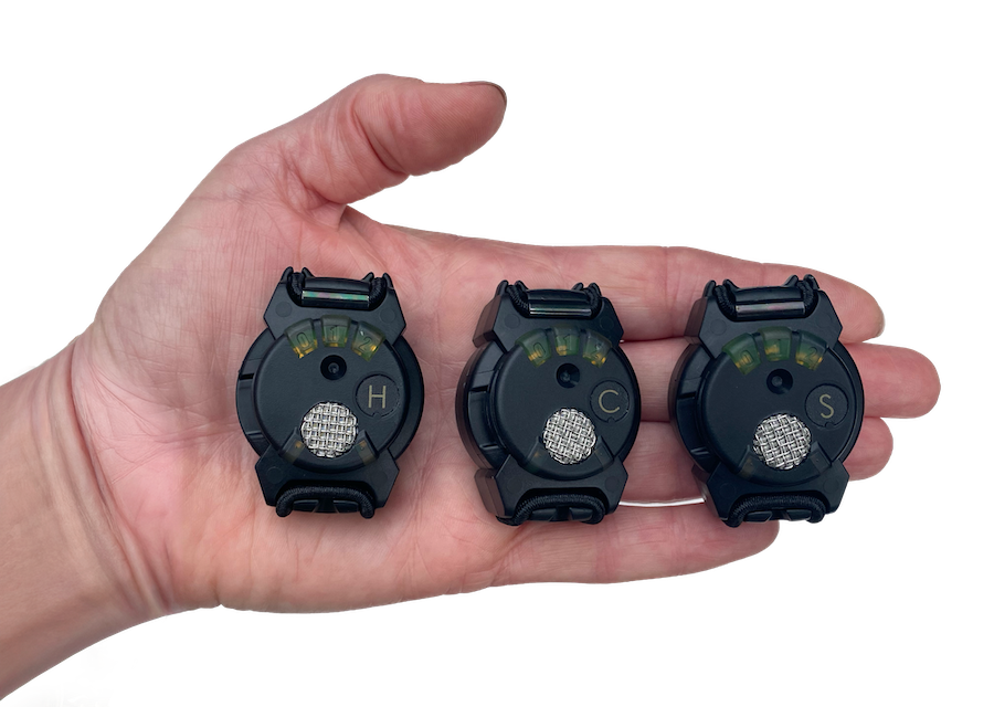 Hand holding three Blast Gauge sensors in open palm